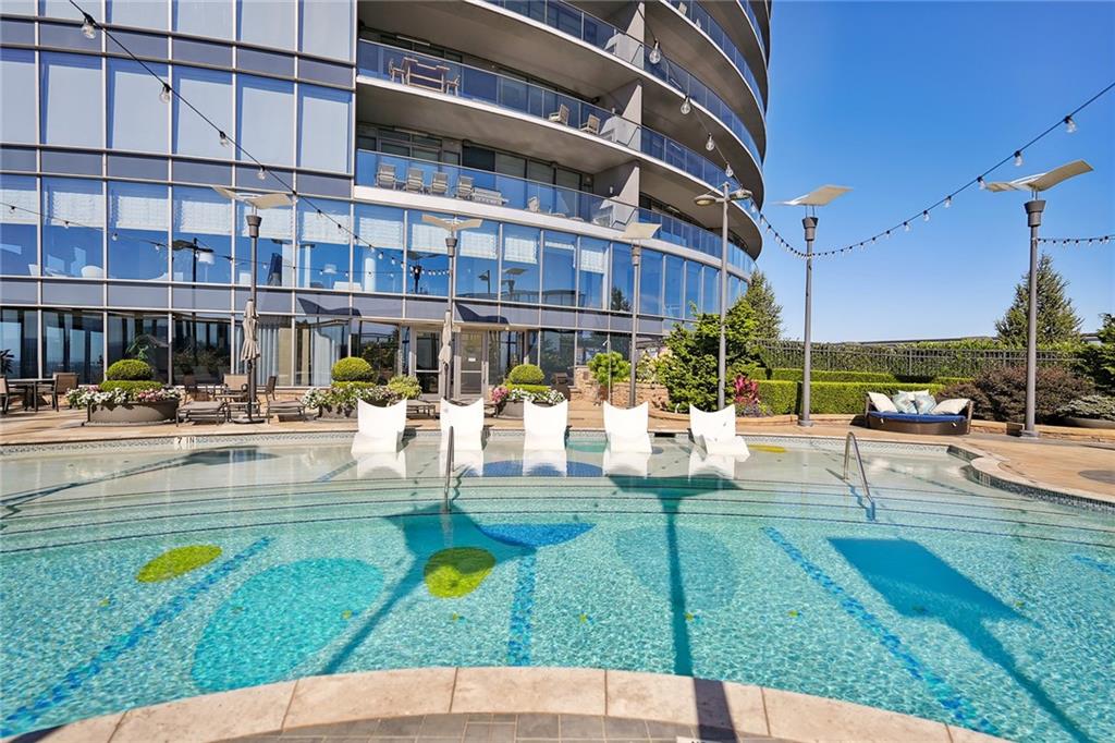 3344 Peachtree Road Northeast, Unit 3202 Atlanta, GA 30326 - Photo 33 of 39 a view of a swimming pool with a bench in front of building