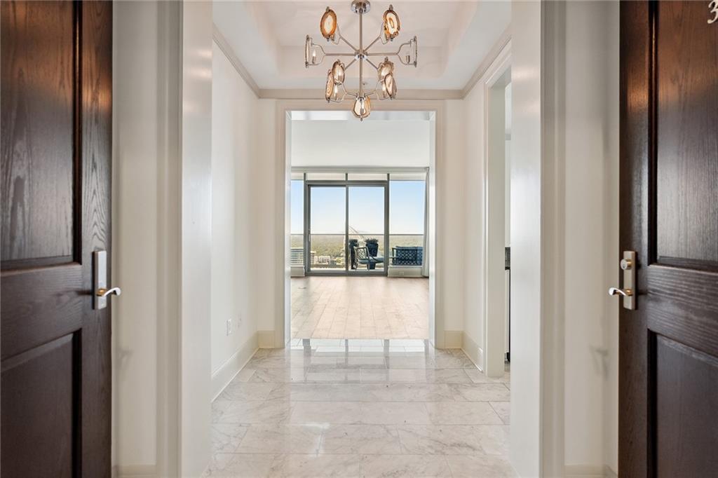 3344 Peachtree Road Northeast, Unit 3202 Atlanta, GA 30326 - Photo 9 of 39 a view of a hallway with a chandelier