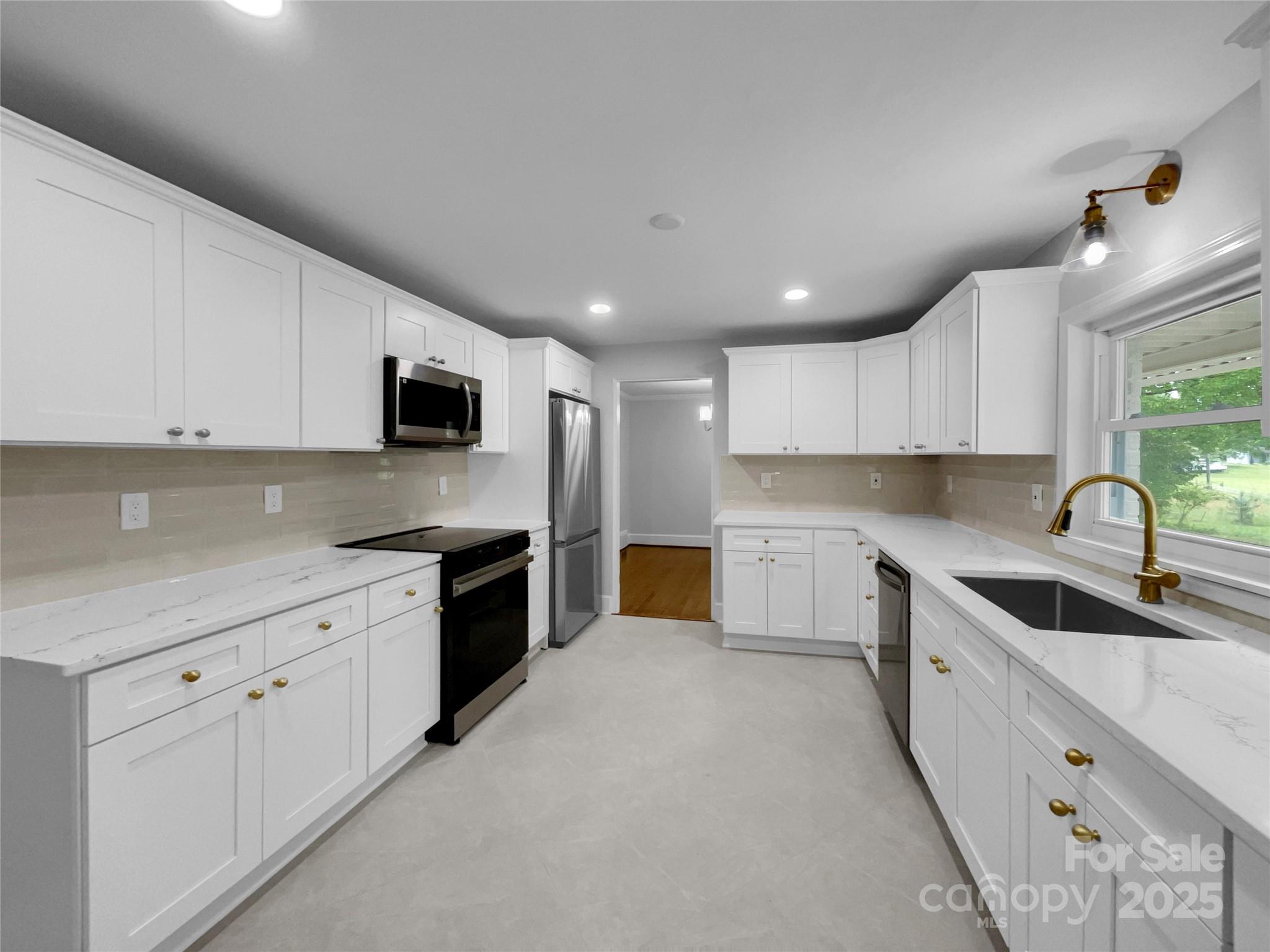 141 Edenvale Road Rock Hill, SC 29730 - Photo 12 of 27 a large kitchen with stainless steel appliances granite countertop a sink and cabinets