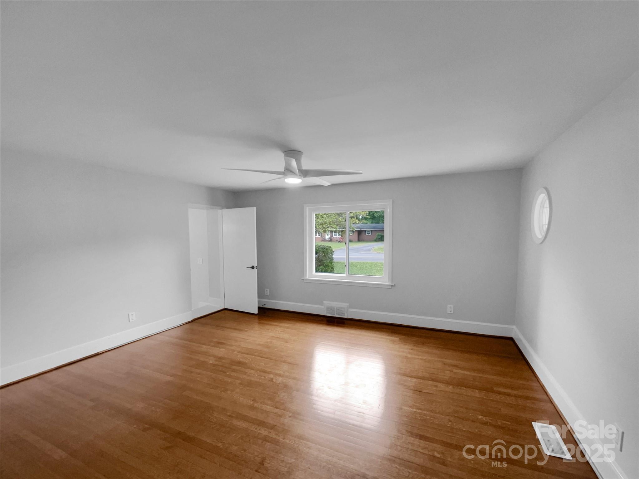 141 Edenvale Road Rock Hill, SC 29730 - Photo 13 of 27 an empty room with wooden floor and windows