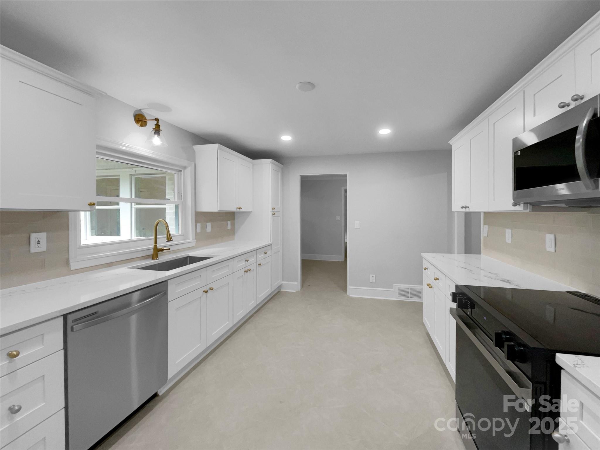 141 Edenvale Road Rock Hill, SC 29730 - Photo 6 of 27 a large kitchen with stainless steel appliances kitchen island granite countertop a sink and cabinets