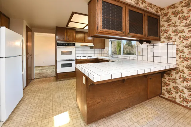 a kitchen with a sink stove and cabinets