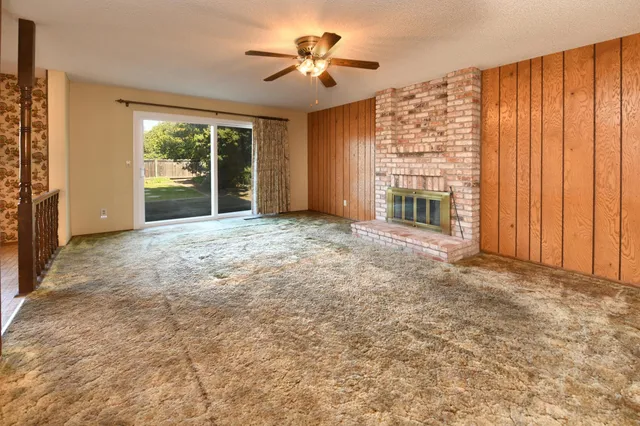 a view of an empty room with a fireplace