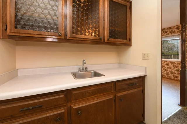 a bathroom with a sink a toilet and mirror