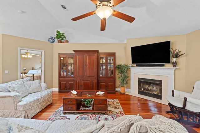 a living room with furniture fireplace and a flat screen tv