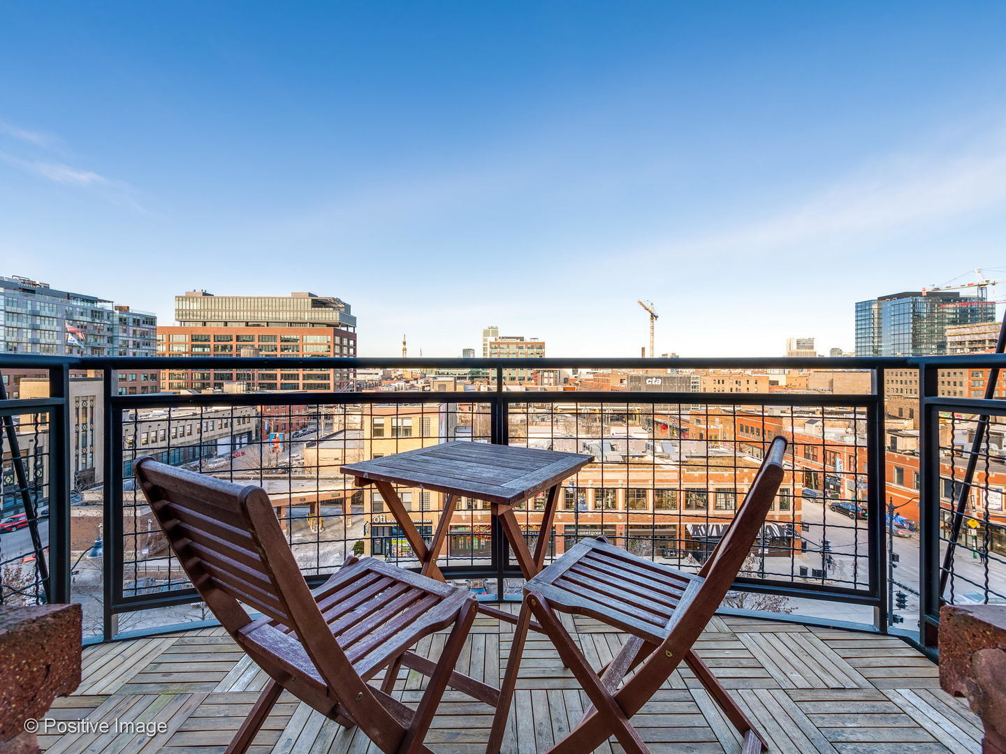 1000 West Washington Boulevard, Unit 540 Chicago, IL 60607 - Photo 15 of 28 a view of a balcony with wooden benches and a wooden floor
