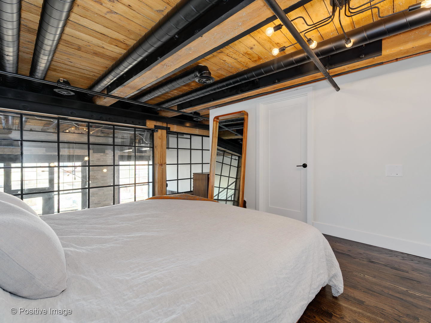 1000 West Washington Boulevard, Unit 540 Chicago, IL 60607 - Photo 16 of 28 a large bed sitting in a bedroom next to a window