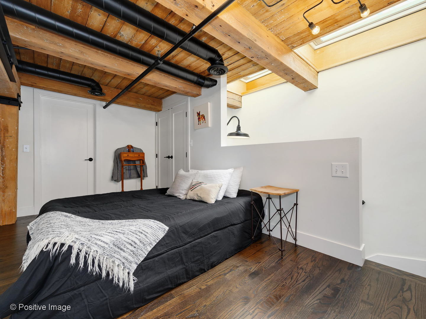 1000 West Washington Boulevard, Unit 540 Chicago, IL 60607 - Photo 22 of 28 a bedroom with a bed and wooden floor