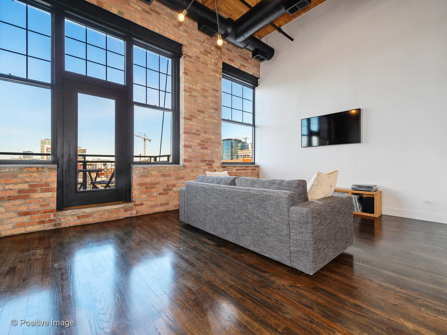 1000 West Washington Boulevard, Unit 540 Chicago, IL 60607 - Photo 4 of 28 a living room with furniture and a flat screen tv