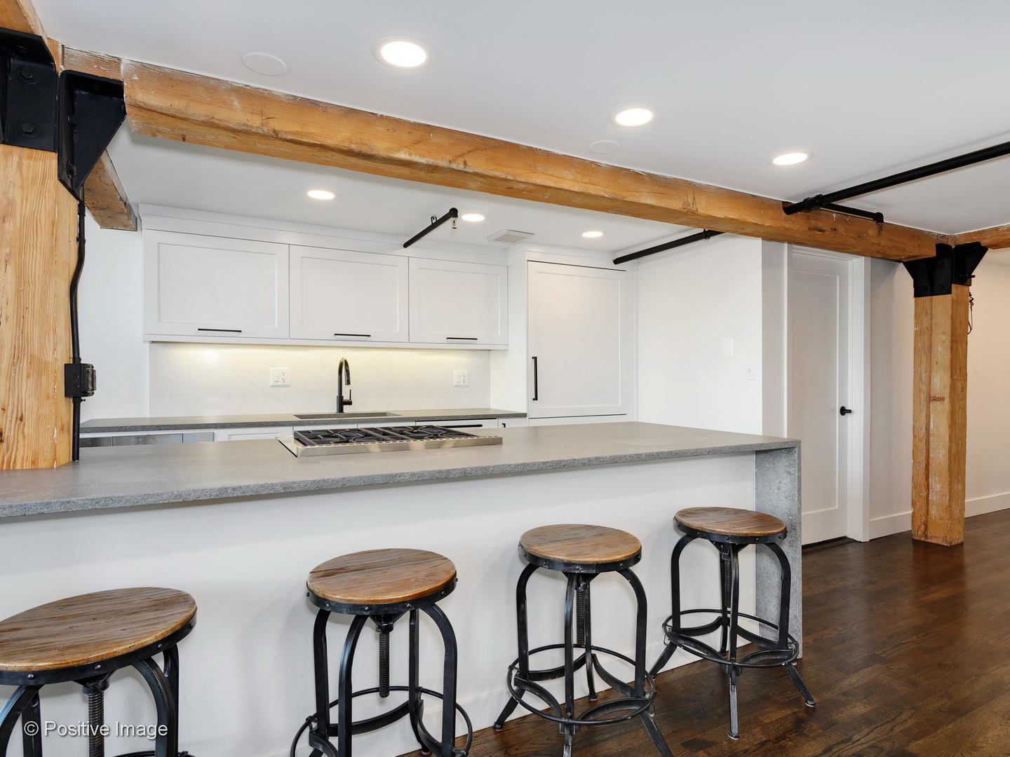 1000 West Washington Boulevard, Unit 540 Chicago, IL 60607 - Photo 6 of 28 a kitchen with stainless steel appliances granite countertop a table chairs in it and wooden floors