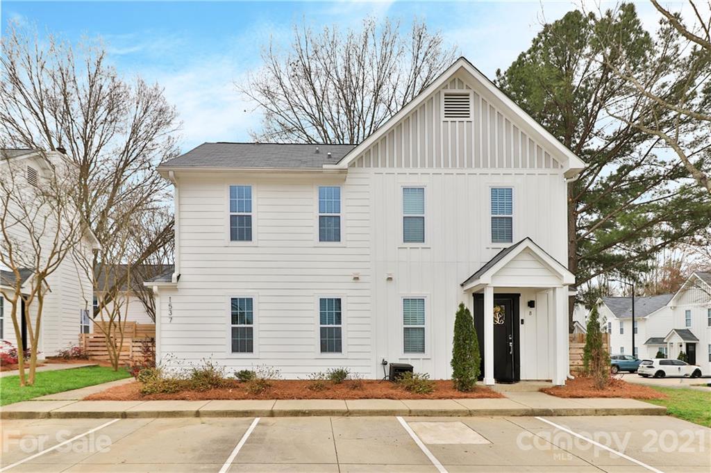 1537 Briar Creek Road, Unit A Charlotte, NC 28205 - Photo 1 of 30 a view of a white house with a yard and large trees