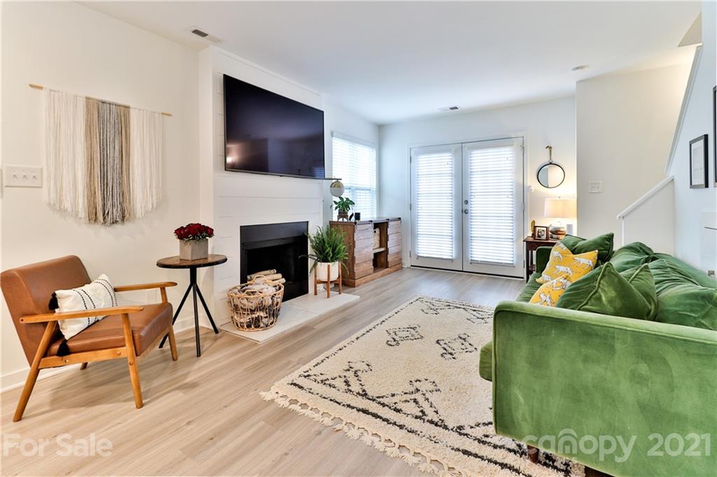 1537 Briar Creek Road, Unit A Charlotte, NC 28205 - Photo 13 of 30 a living room with furniture a flat screen tv and a fireplace