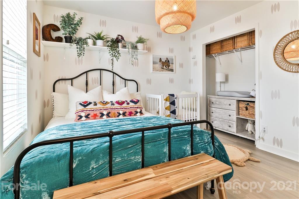 1537 Briar Creek Road, Unit A Charlotte, NC 28205 - Photo 20 of 30 a bedroom with a bed and a dresser in it