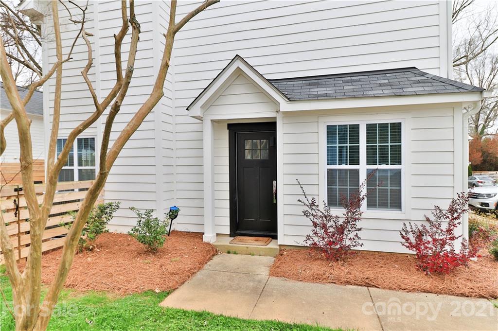1537 Briar Creek Road, Unit A Charlotte, NC 28205 - Photo 3 of 30 a front view of a house with a yard and potted plants