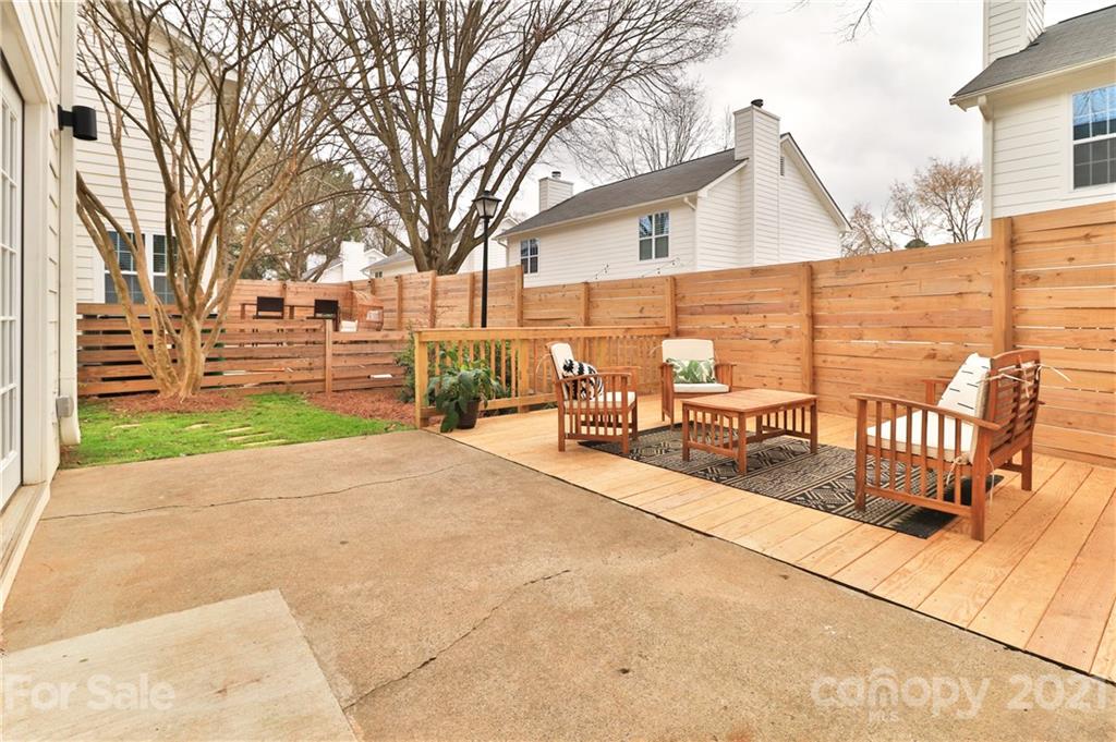 1537 Briar Creek Road, Unit A Charlotte, NC 28205 - Photo 24 of 30 a view of a patio with chair and table and chairs and floor to ceiling window