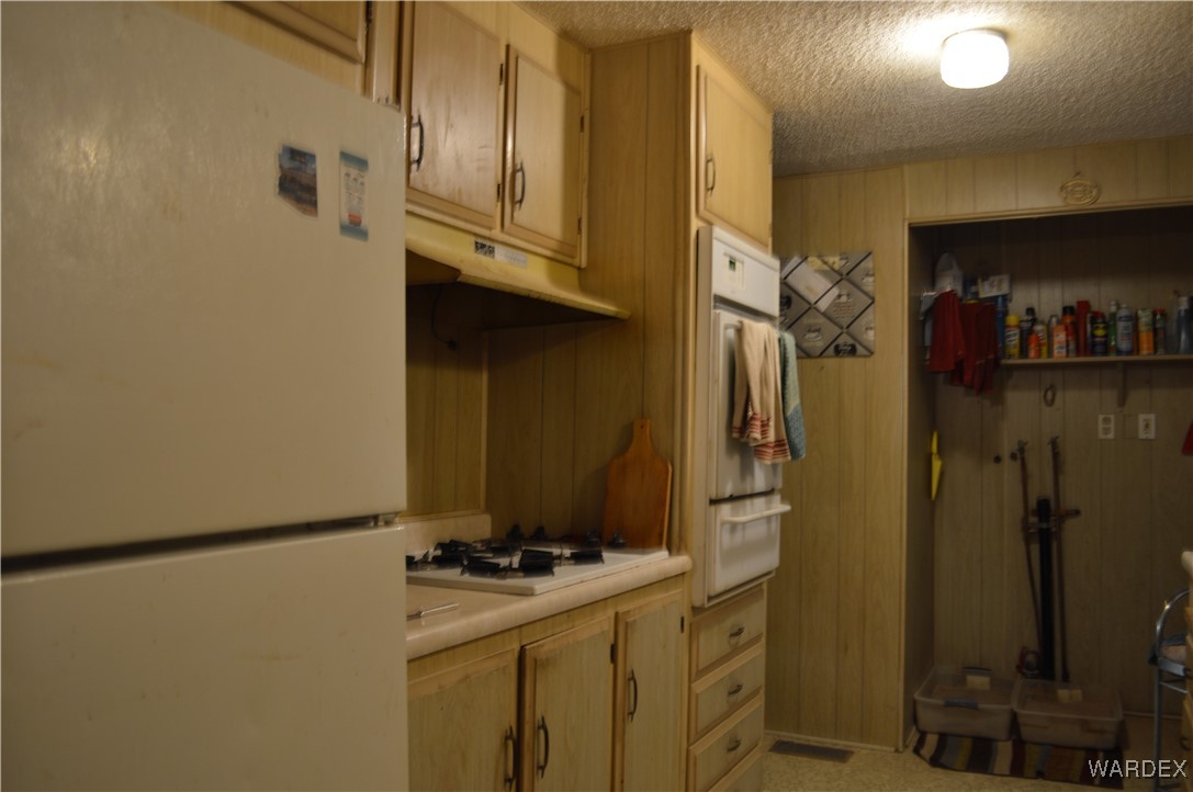 1359 Lause Road Bullhead City, AZ 86442 - Photo 4 of 17 a kitchen with a refrigerator and a stove