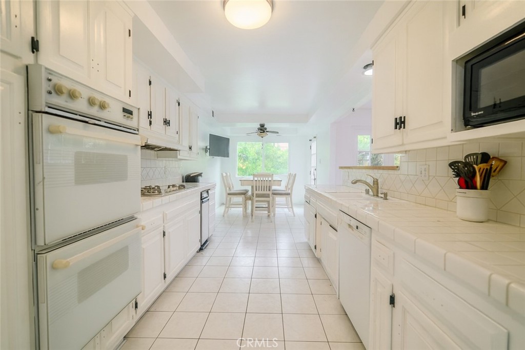 18351 San Fernando Mission Boulevard Porter Ranch, CA 91326 - Photo 11 of 29 a kitchen with stainless steel appliances a sink stove and cabinets