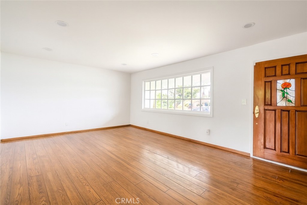 18351 San Fernando Mission Boulevard Porter Ranch, CA 91326 - Photo 3 of 29 an empty room with wooden floor and windows