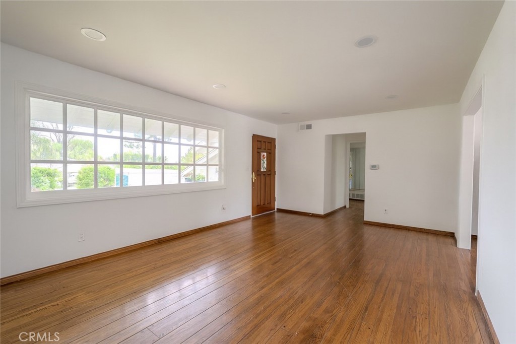 18351 San Fernando Mission Boulevard Porter Ranch, CA 91326 - Photo 4 of 29 an empty room with wooden floor and windows