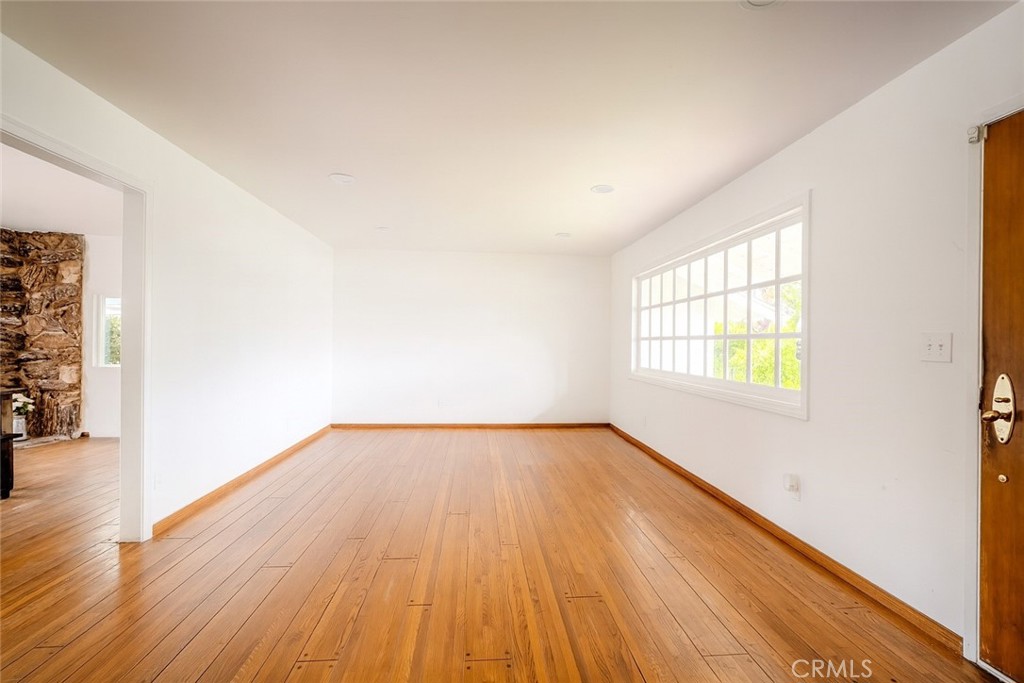 18351 San Fernando Mission Boulevard Porter Ranch, CA 91326 - Photo 5 of 29 an empty room with wooden floor and windows