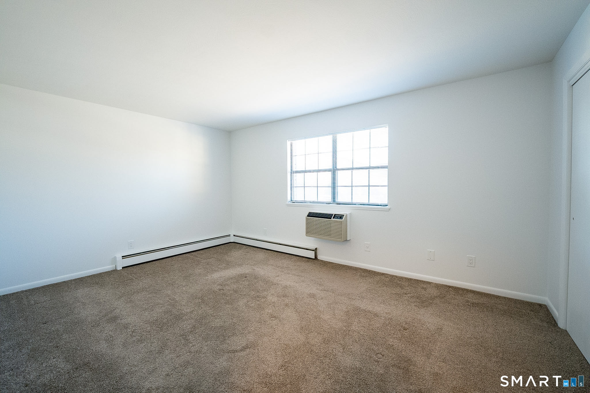 38 Enid Street, Unit B Bridgeport, CT 06606 - Photo 4 of 10 an empty room with windows