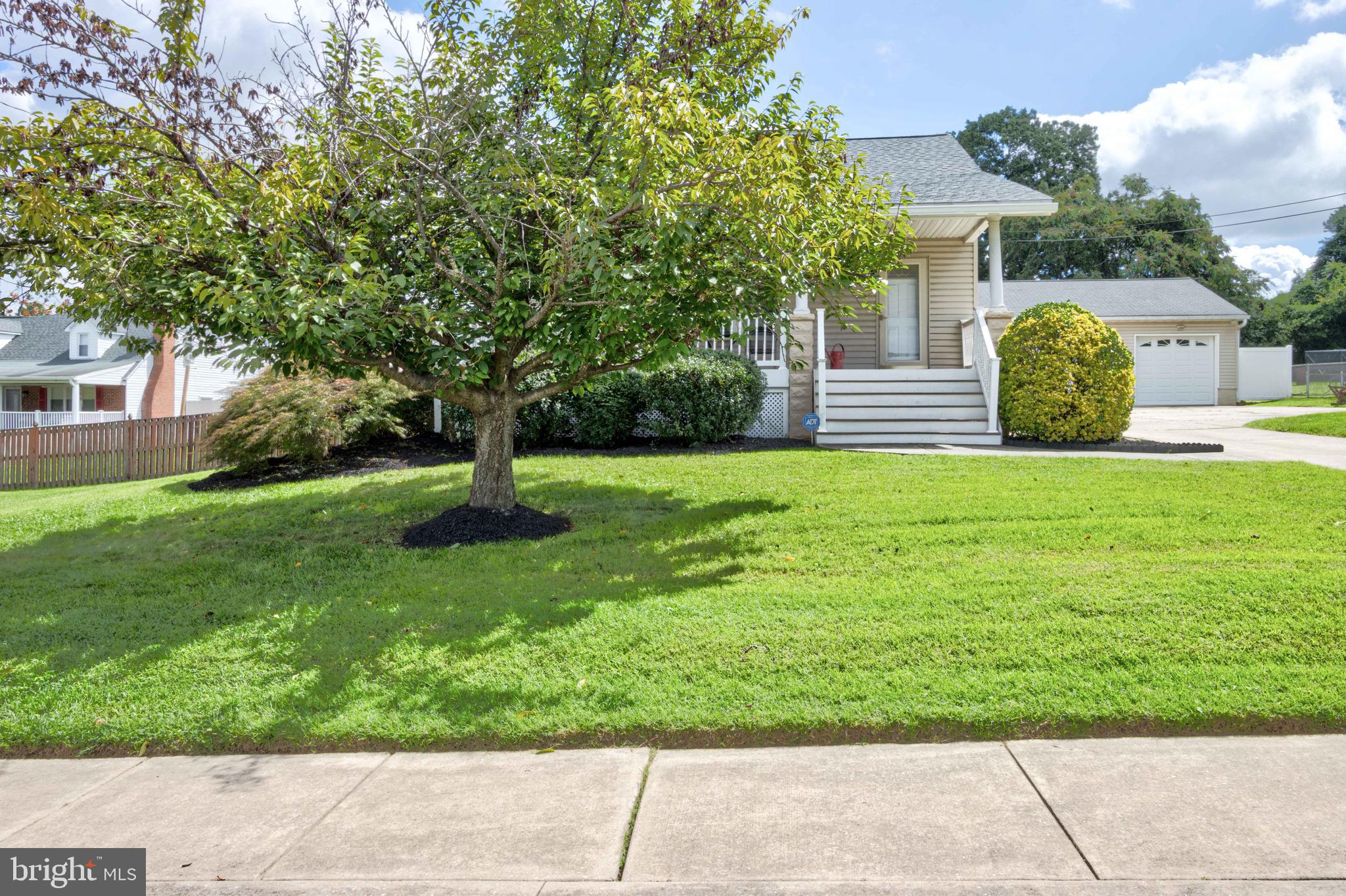 2025 Northeast Ne Baltimore, MD 21227 - Photo 2 of 122 a view of a garden with plants and large trees