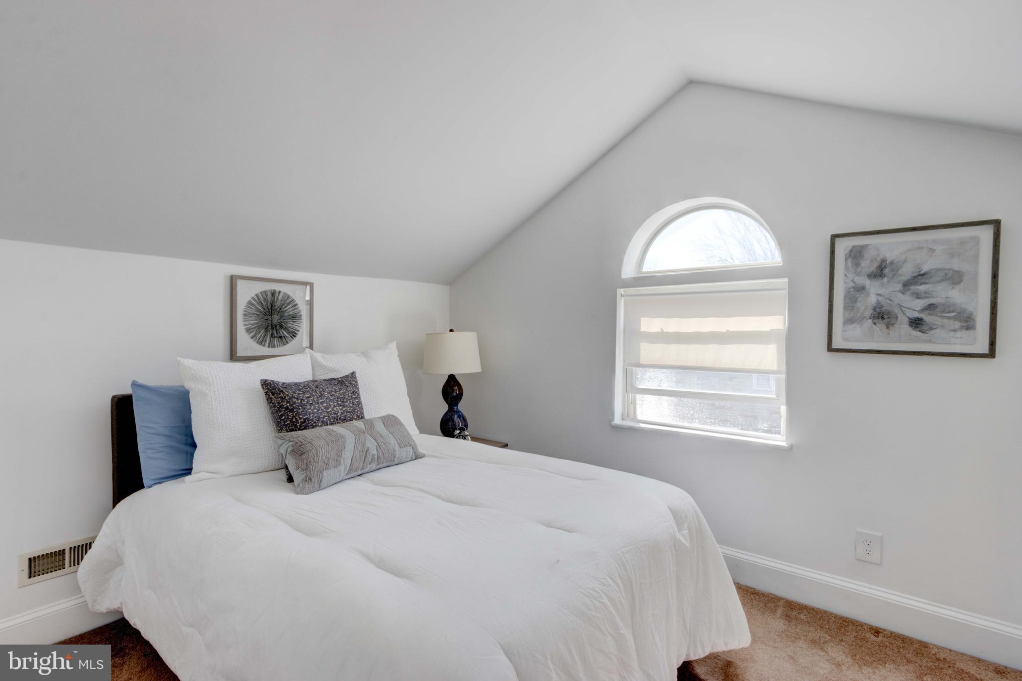 2025 Northeast Ne Baltimore, MD 21227 - Photo 65 of 122 a bedroom with a bed and a window