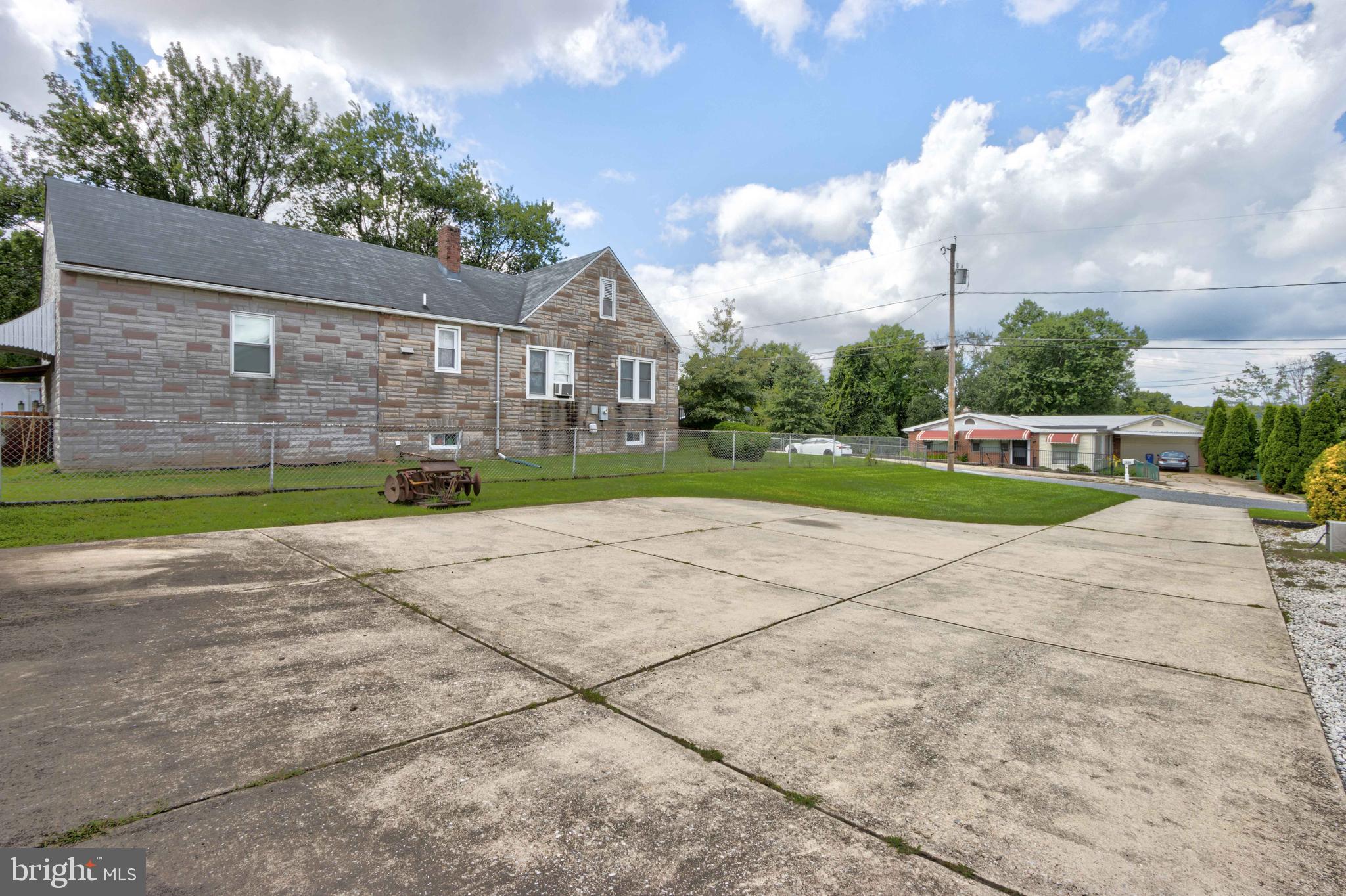 2025 Northeast Ne Baltimore, MD 21227 - Photo 75 of 122 a front view of a house with a yard and trees