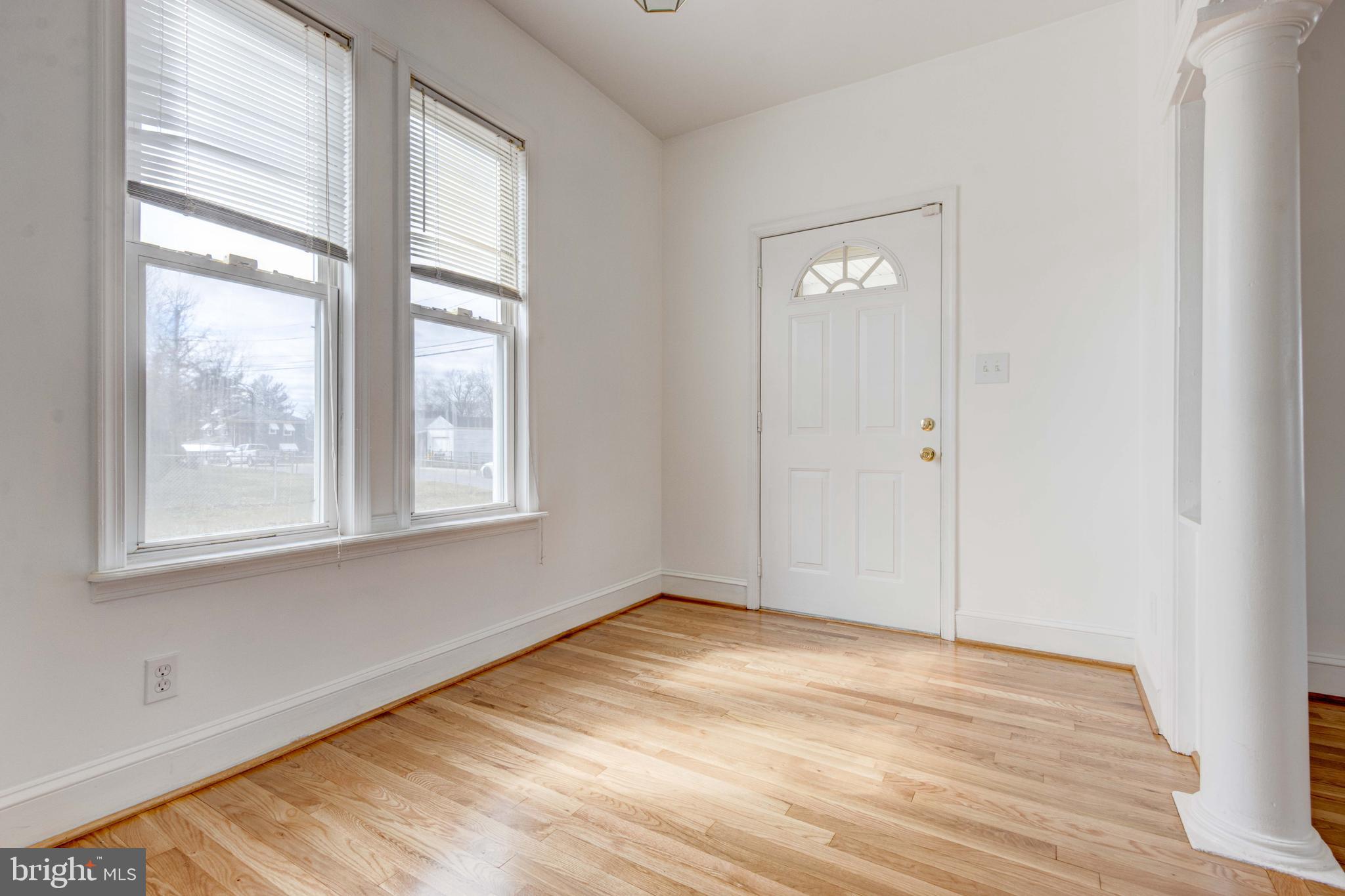 2025 Northeast Ne Baltimore, MD 21227 - Photo 99 of 122 a view of an empty room with wooden floor and a window