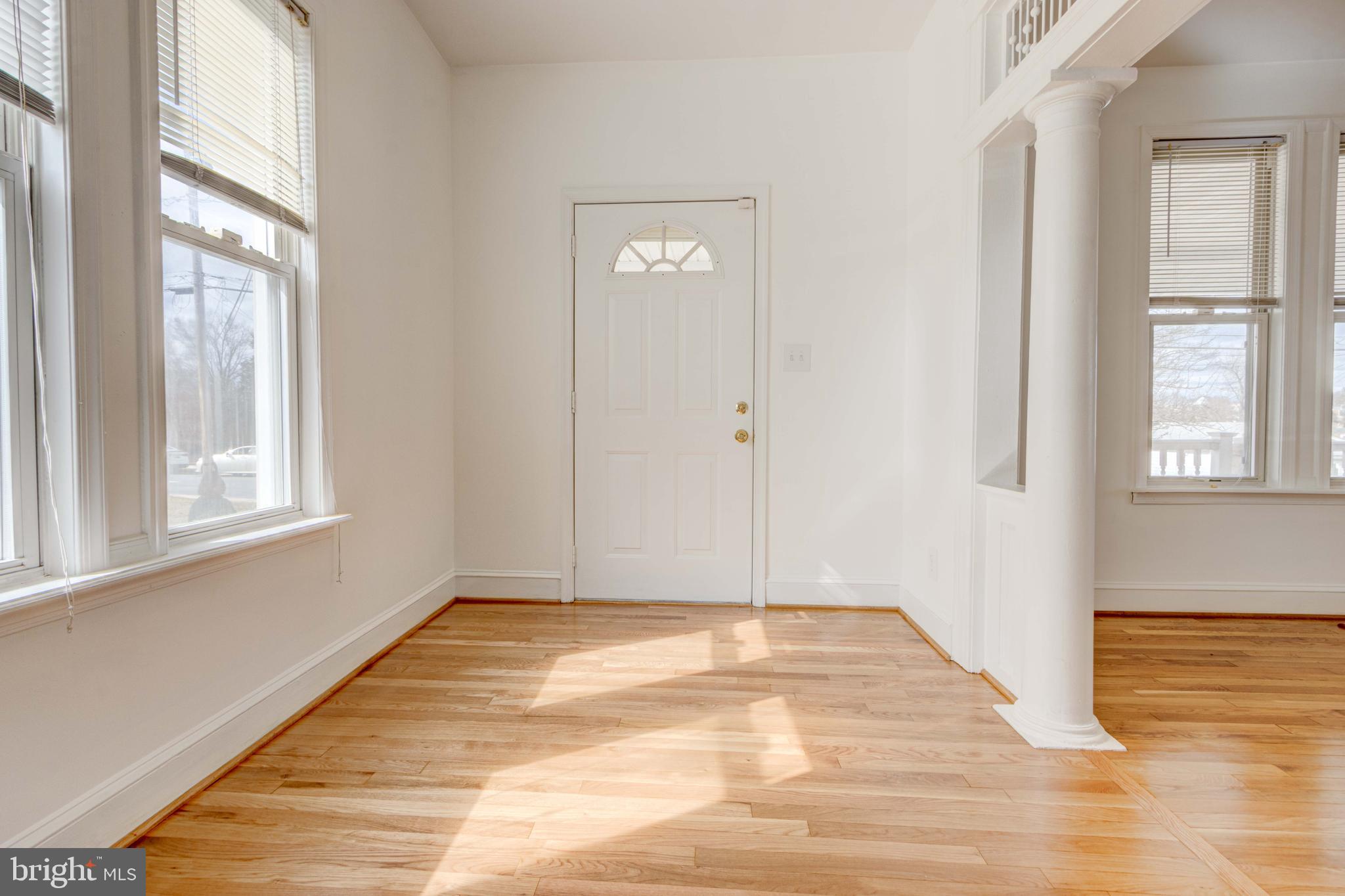 2025 Northeast Ne Baltimore, MD 21227 - Photo 100 of 122 a view of an empty room with wooden floor and a window