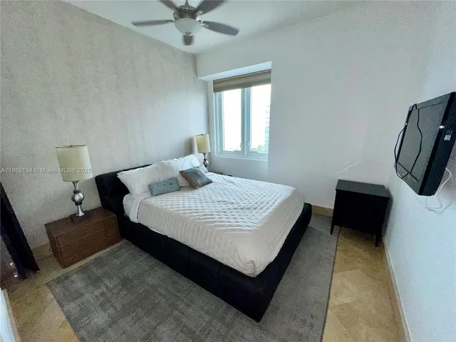 a bedroom with a bed a couch and a window