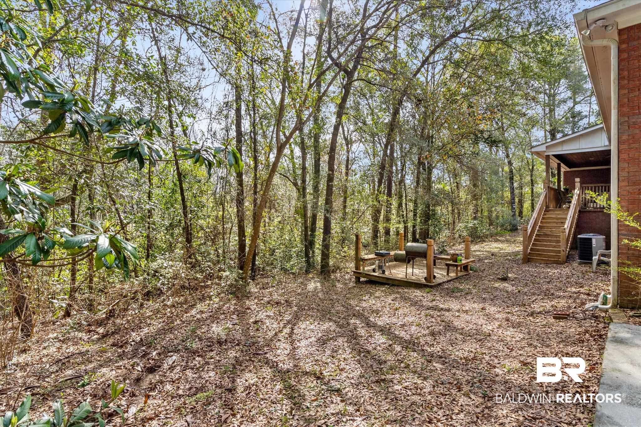 2400 Waterford Road Semmes, AL 36575 - Photo 27 of 30 View of yard with stairs and a deck