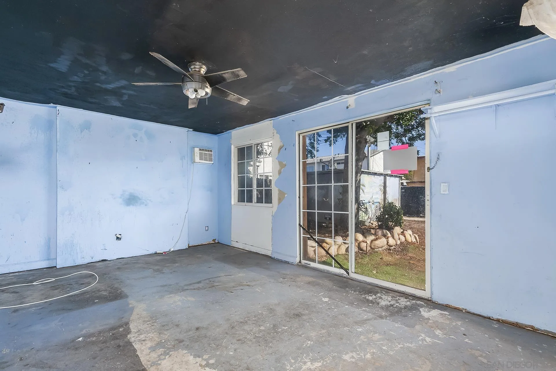 4539 Gila Avenue San Diego, CA 92117 - Photo 16 of 27 a view of a livingroom with a ceiling fan & window