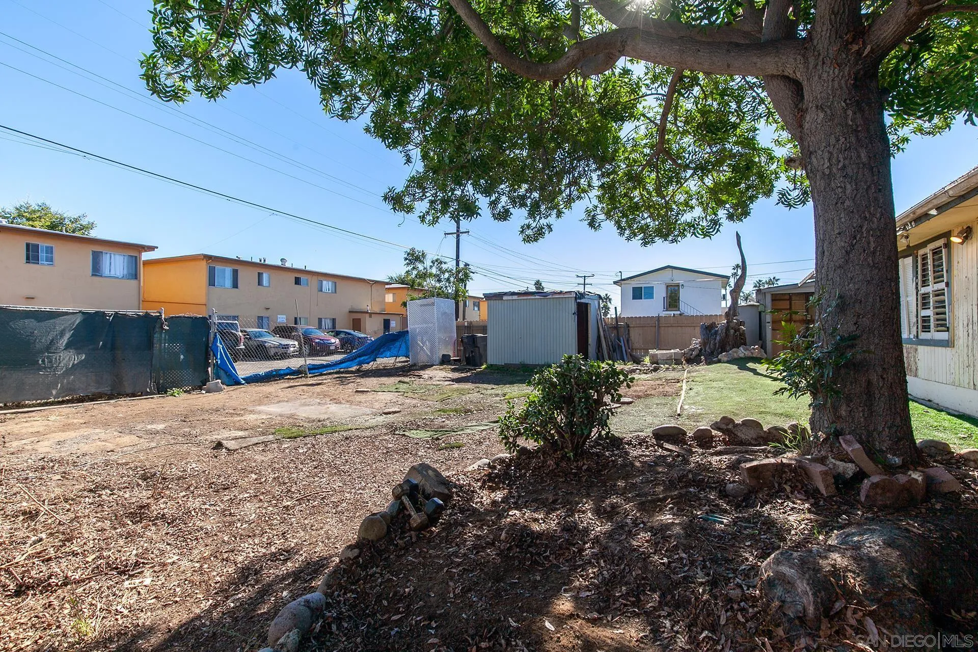 4539 Gila Avenue San Diego, CA 92117 - Photo 22 of 27 a front view of a house with a yard and a tree