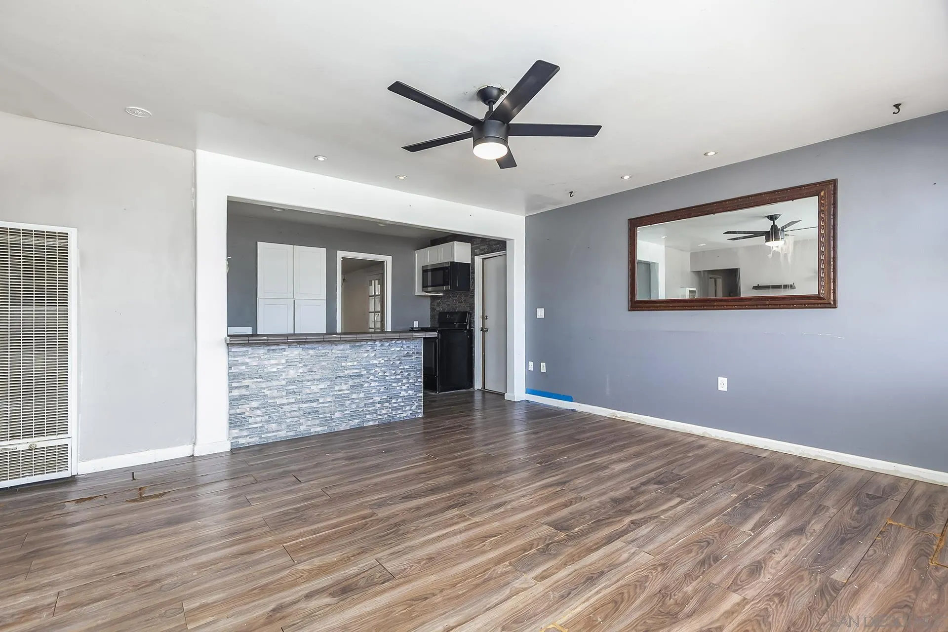 4539 Gila Avenue San Diego, CA 92117 - Photo 6 of 27 a view of empty room with wooden floor and ceiling fan