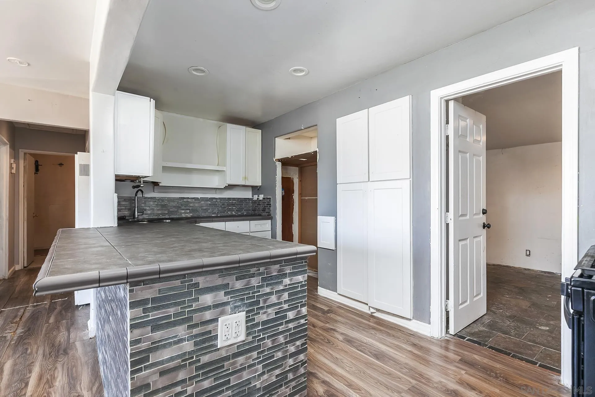 4539 Gila Avenue San Diego, CA 92117 - Photo 7 of 27 a kitchen with stainless steel appliances granite countertop a refrigerator and a sink