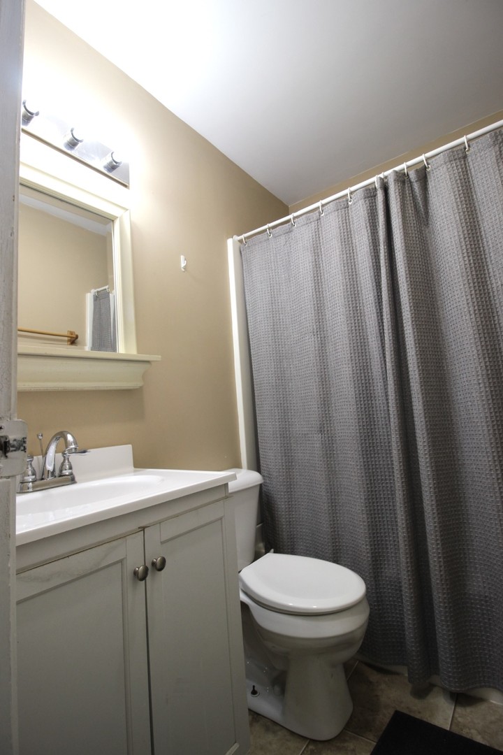 800 Bryan Street Normal, IL 61761 - Photo 19 of 27 a bathroom with a sink and a mirror