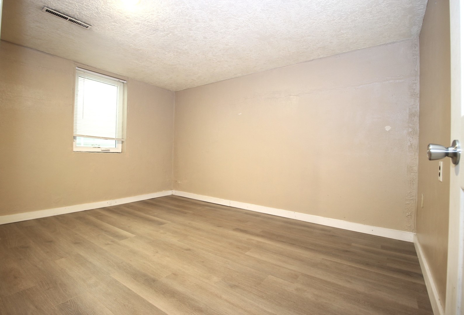 800 Bryan Street Normal, IL 61761 - Photo 21 of 27 an empty room with wooden floor and windows
