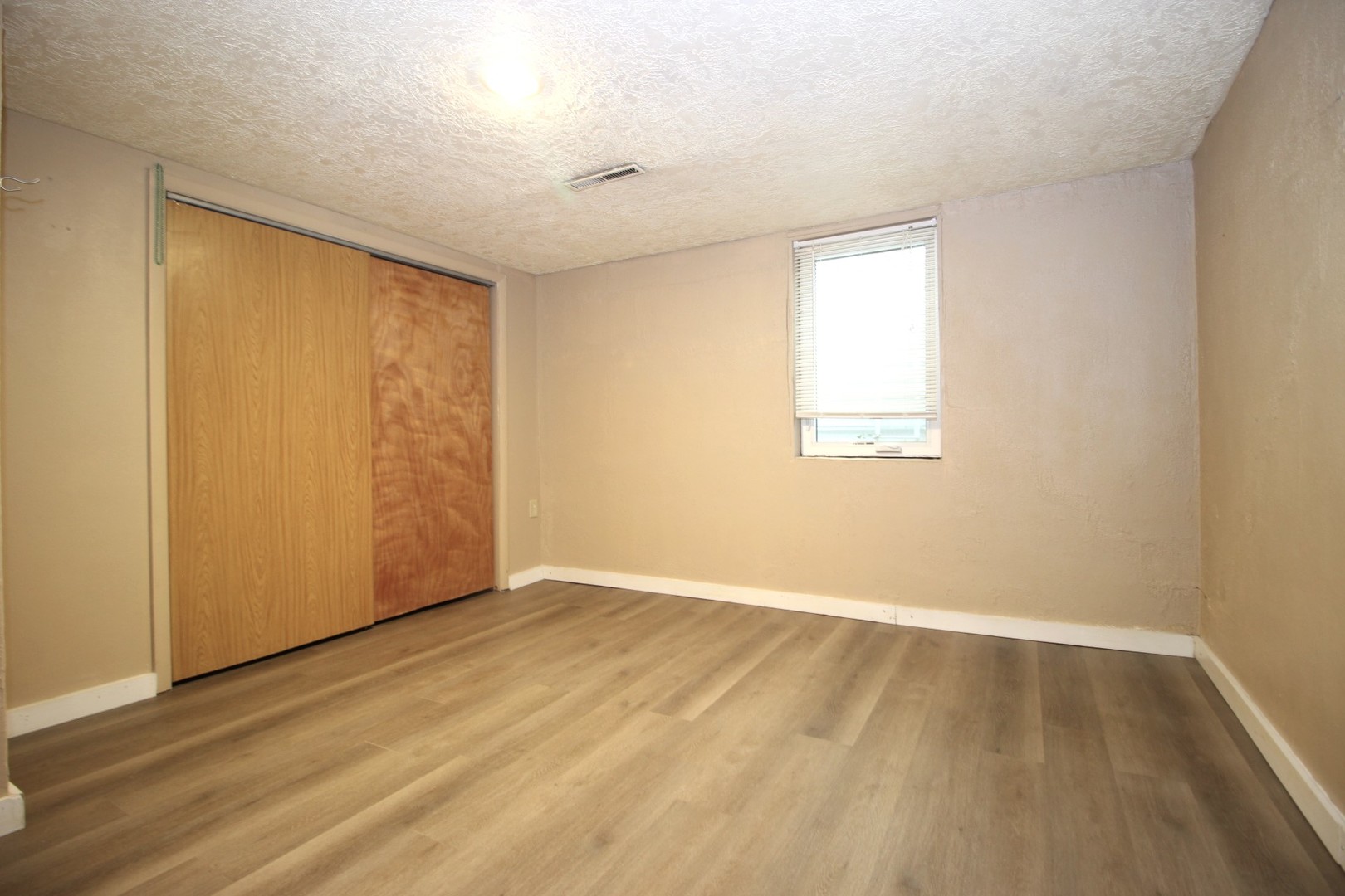 800 Bryan Street Normal, IL 61761 - Photo 22 of 27 an empty room with wooden floor and windows