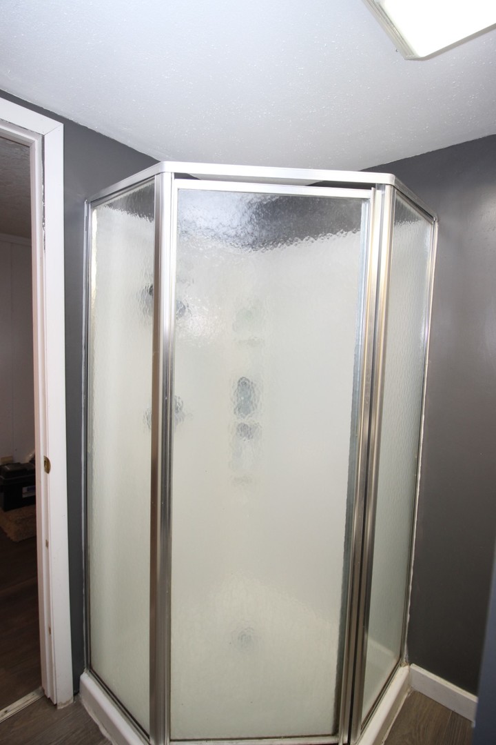800 Bryan Street Normal, IL 61761 - Photo 26 of 27 a bathroom with a glass shower door