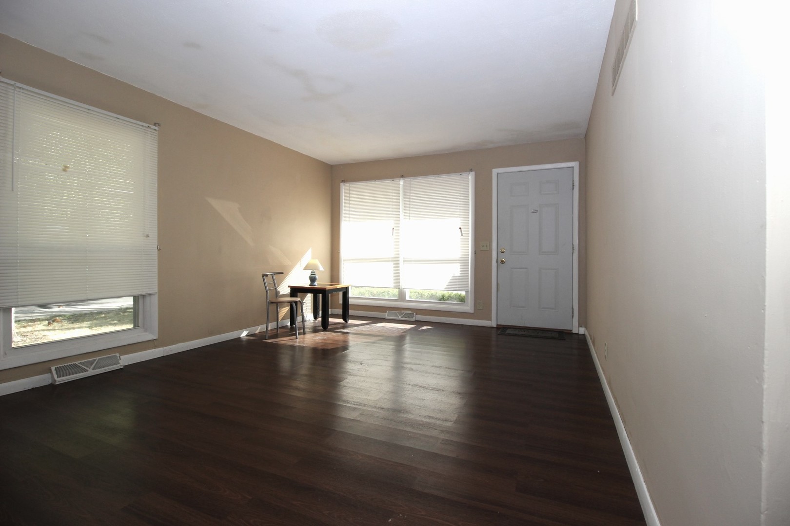 800 Bryan Street Normal, IL 61761 - Photo 9 of 27 a view of an empty room with wooden floor and a window