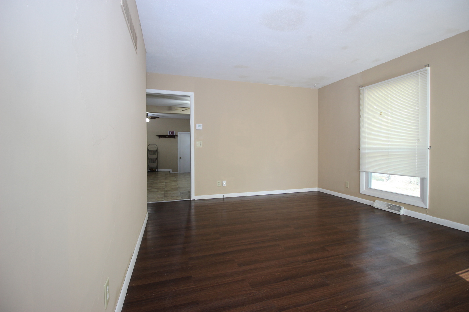 800 Bryan Street Normal, IL 61761 - Photo 10 of 27 a view of an empty room with wooden floor and a window