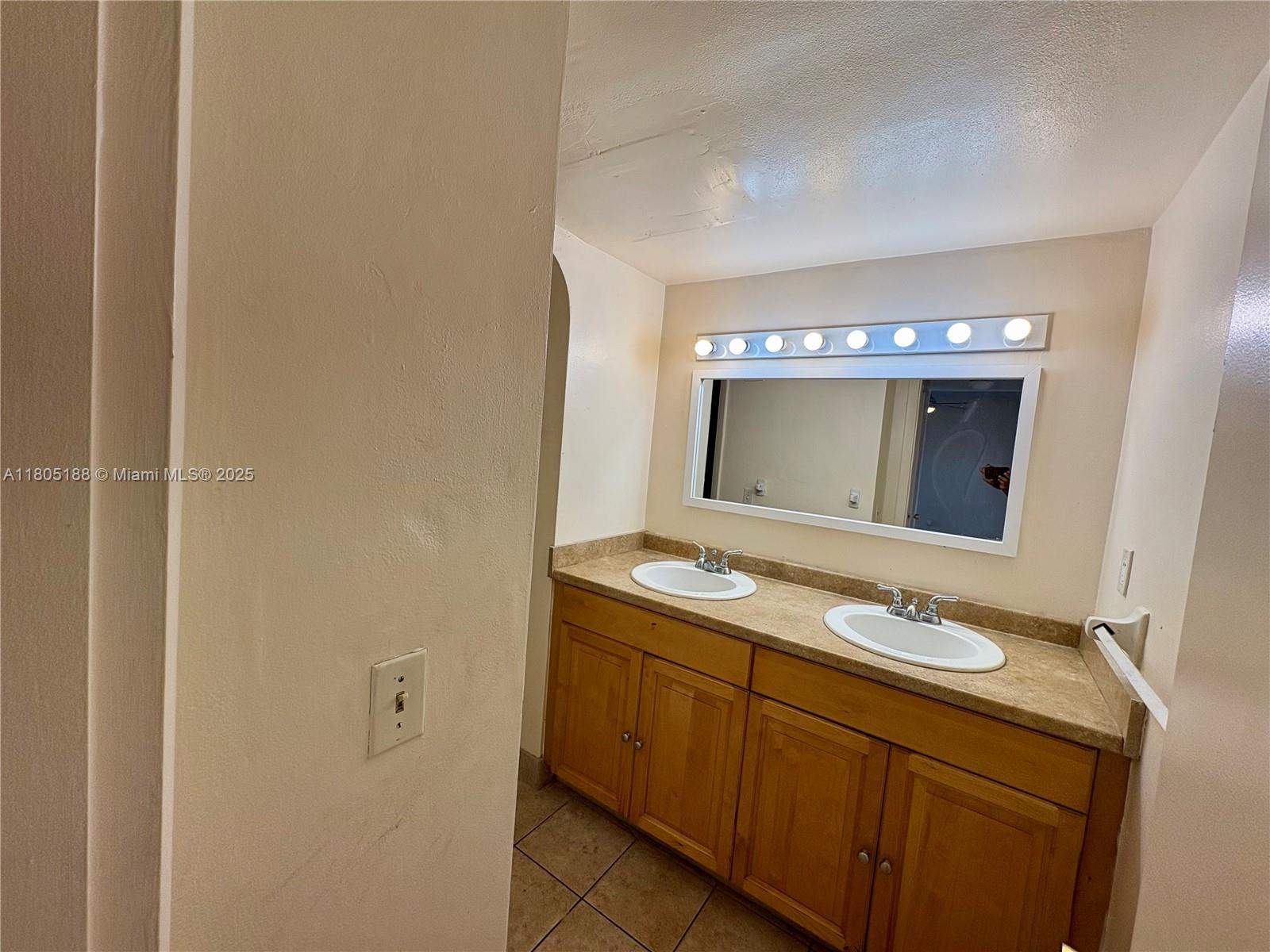 Fifth Moorings Condominium Miami, FL 33179 - Photo 14 of 29 a bathroom with a sink and a mirror