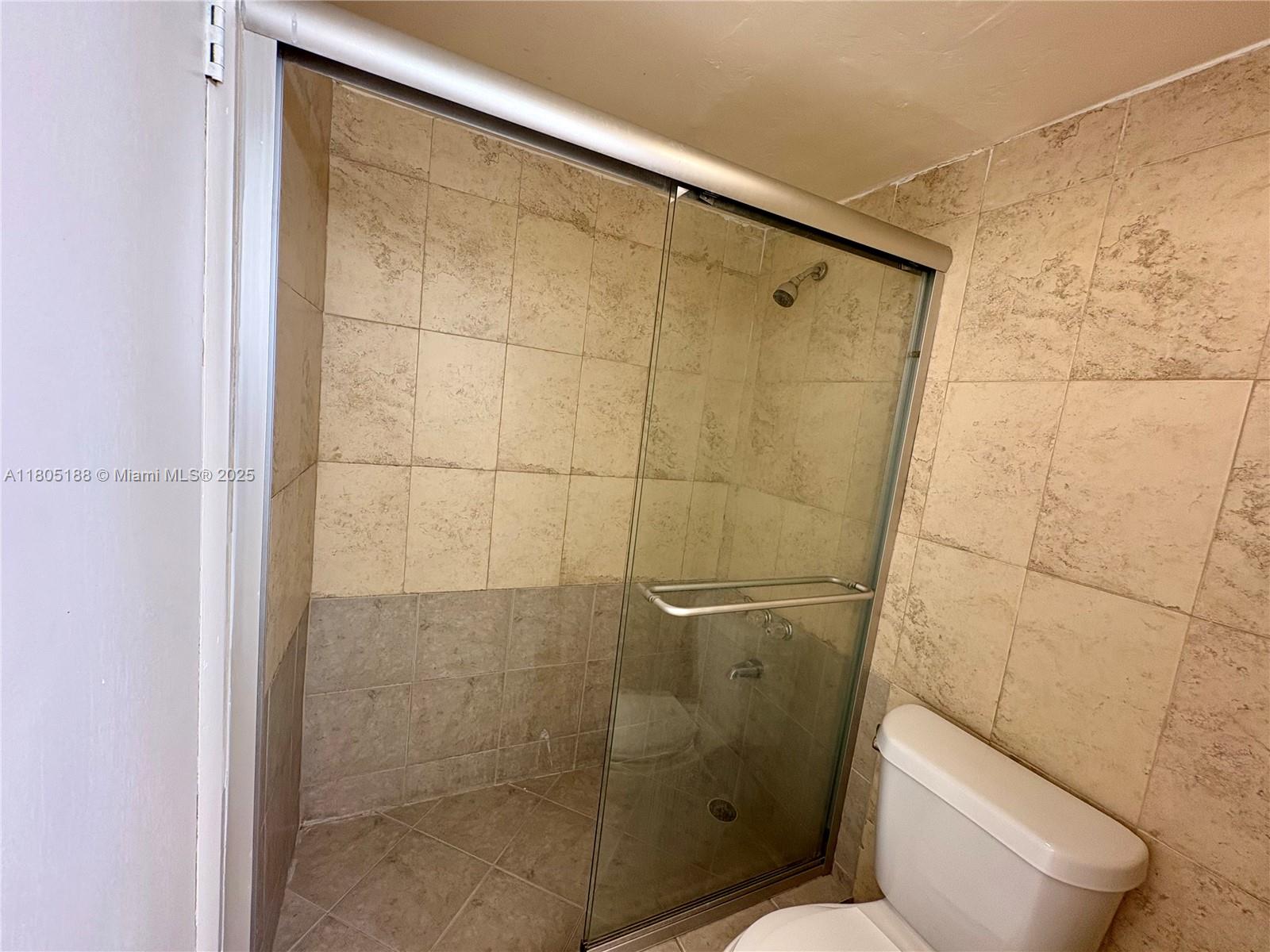Fifth Moorings Condominium Miami, FL 33179 - Photo 16 of 29 a bathroom with a toilet and a shower