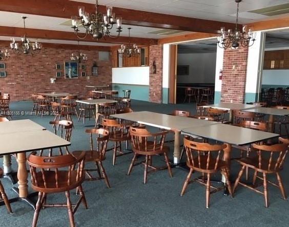 Fifth Moorings Condominium Miami, FL 33179 - Photo 26 of 29 a view of a dining room with furniture and chandelier