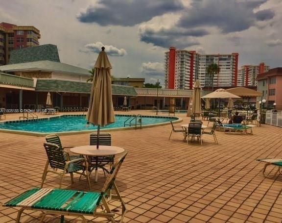Fifth Moorings Condominium Miami, FL 33179 - Photo 5 of 29 a view of a patio with a table chairs and a wooden fence