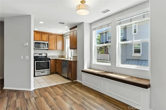 a kitchen with stainless steel appliances granite countertop a stove and a refrigerator