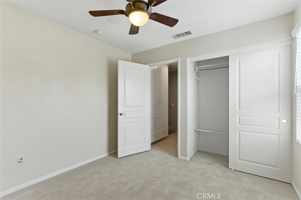 57 Hinterland Way Ladera Ranch, CA 92694 - Photo 19 of 41 an empty room with closet and a chandelier fan