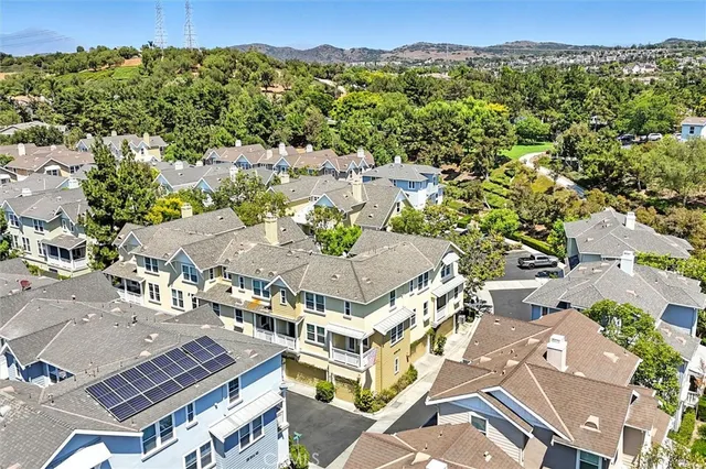an aerial view of a residential apartment building with a yard