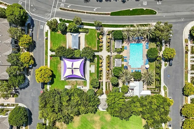 an aerial view of a house with a yard and green space